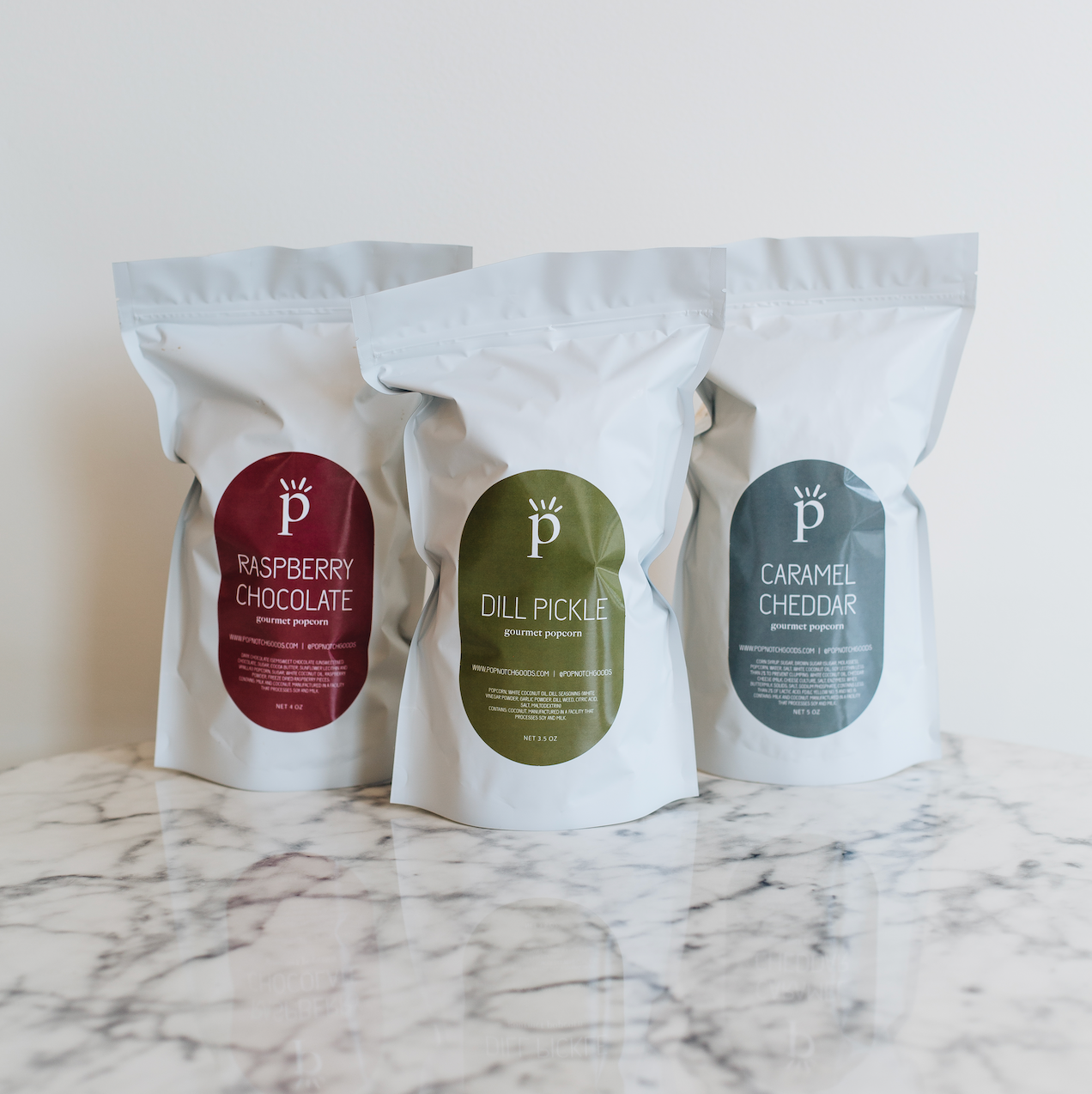 Best Seller Sampler Pack includes Raspberry Chocolate popcorn, Dill Pickle popcorn, and Caramel Cheddar popcorn. This sampler pack makes a great gift or eases decision making. Popnotch Goods is located in Grand Rapids Michigan on Wealthy Street. Grand Rapids Popcorn.