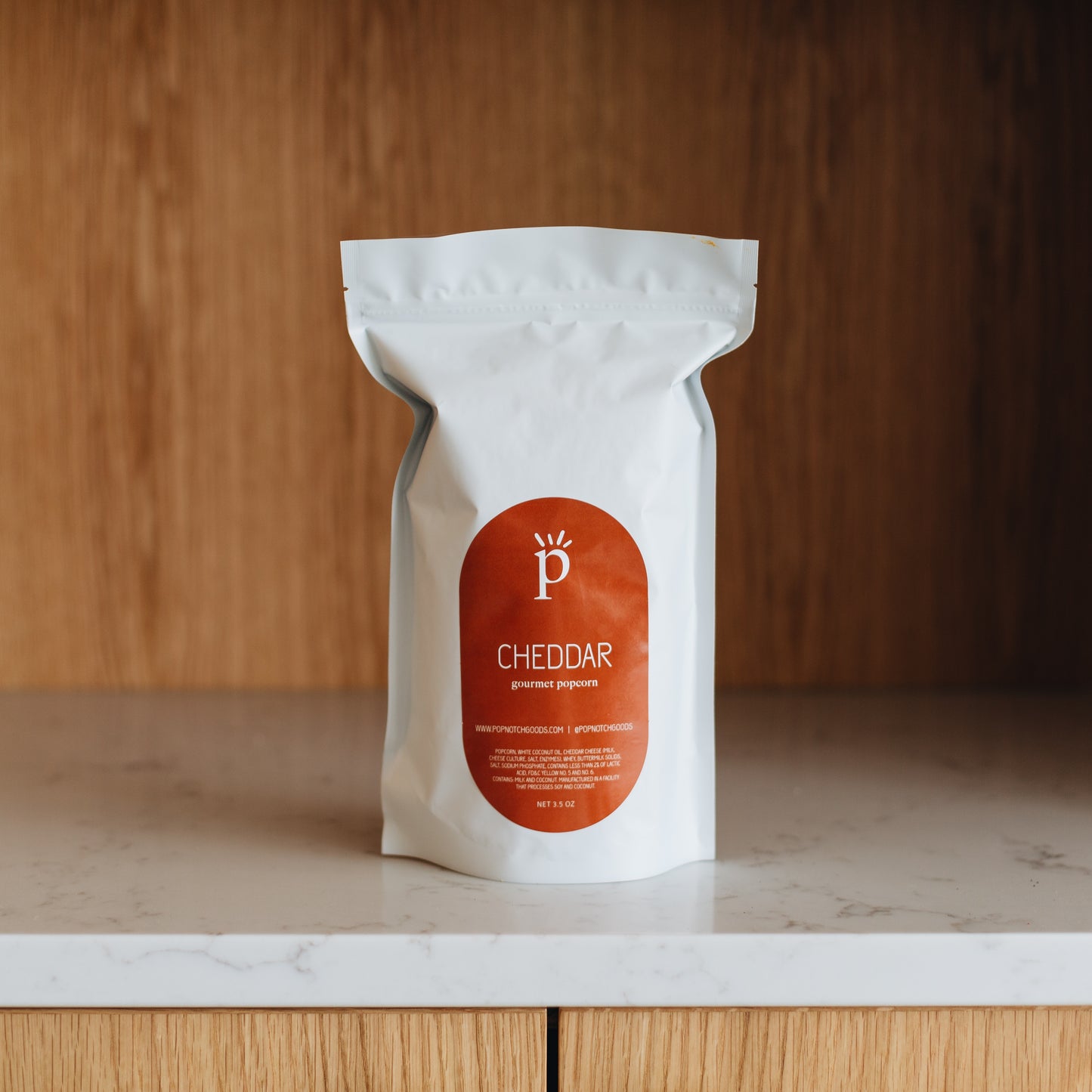 A true classic popcorn. Our Cheddar is creamy with a perfect crunchy popcorn. Get this wonderful tasting popcorn now. Order it online or stop in Popnotch Goods to get the best tasting cheddar popcorn. Featured is our Large bag of Cheddar Popcorn (3.5oz)