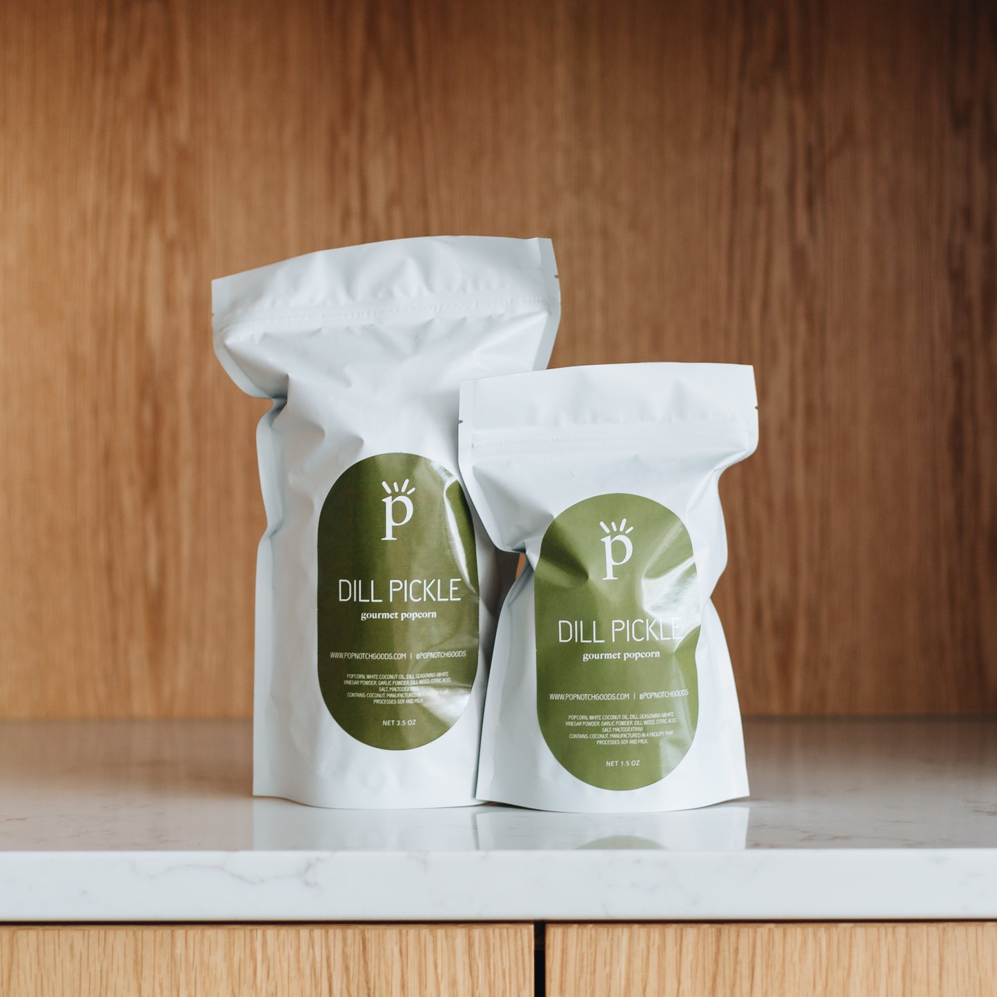 A perfectly seasoned Dill Pickle popcorn. A combination of salt and vinegar with a hint of Dill satisfies all your salty popcorn needs. Pick up a bag at Popnotch Goods or order online now to enjoy this uniquely flavored popcorn! Featured is our Large Bag (3.5oz) and Small Bag (1.5oz)