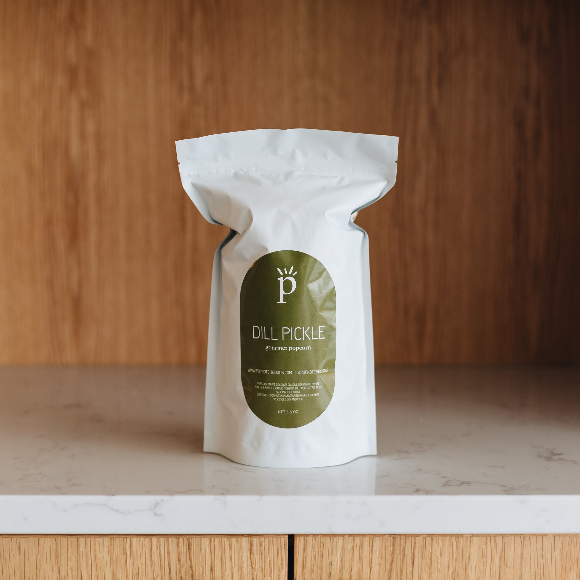 A perfectly seasoned Dill Pickle popcorn. A combination of salt and vinegar with a hint of Dill satisfies all your salty popcorn needs. Pick up a bag at Popnotch Goods or order online now to enjoy this uniquely flavored popcorn! Featured is our Large Bag (3.5oz).